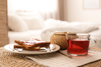 Toasts and tea on table indoors. Delicious morning meal