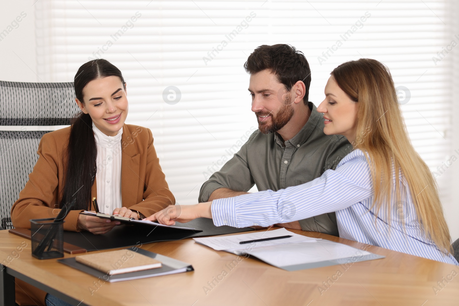 Photo of Couple having meeting with lawyer in office