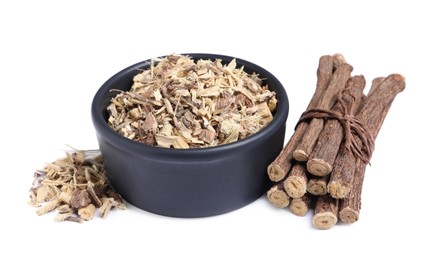 Photo of Dried sticks of liquorice root and shavings on white background
