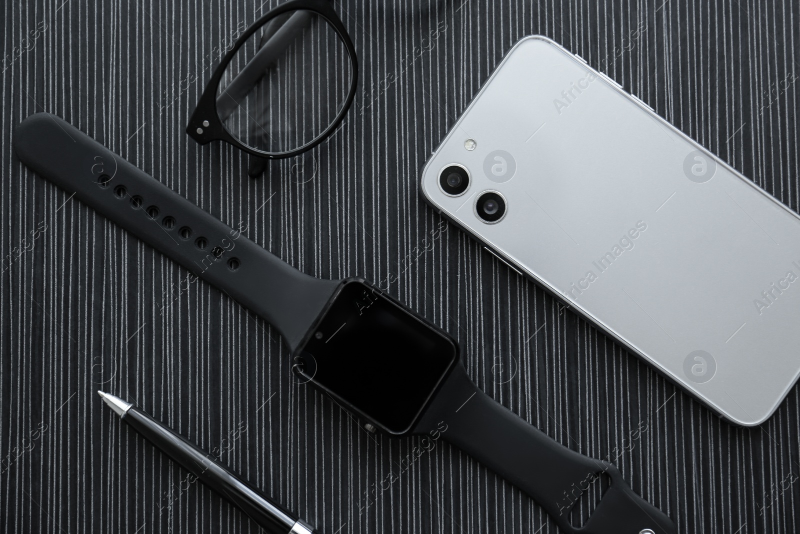 Flat lay composition with stylish smart watch on black table Photo of Flat lay composition with stylish smart watch on black table