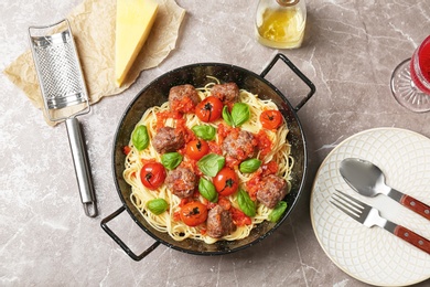 Photo of Pasta with meatballs and tomato sauce on light background