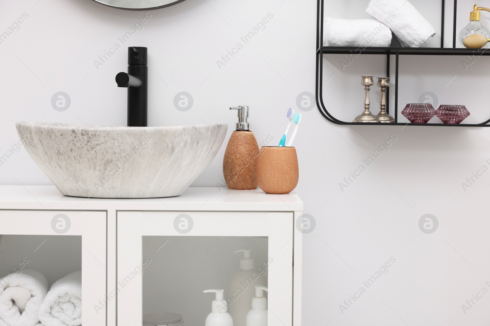 Photo of Different bath accessories, personal care products and bathroom vanity indoors