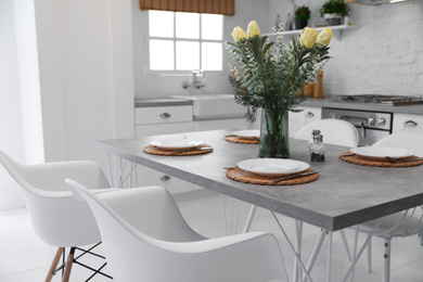 Photo of Elegant table setting in stylish kitchen. Interior design