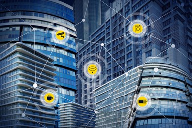 Different virtual icons and modern buildings on background. Smart city concept