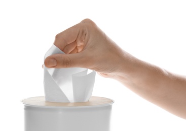 Woman taking paper tissue from holder on white background, closeup