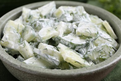 Photo of Delicious cucumber salad in bowl, closeup view