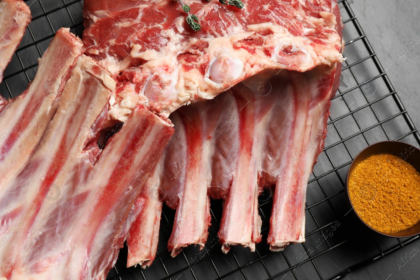 Photo of Raw ribs and spice on cooling rack, closeup