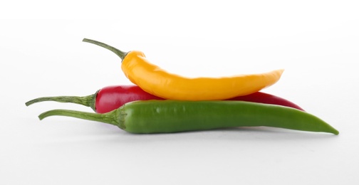 Photo of Ripe hot chili peppers on white background