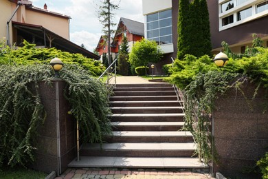 Photo of View of outdoor stairs and green plants in residential area