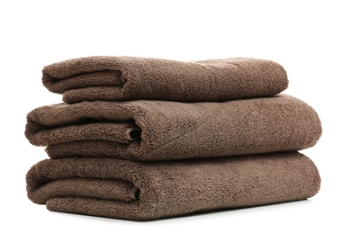 Stack of clean folded towels on white background