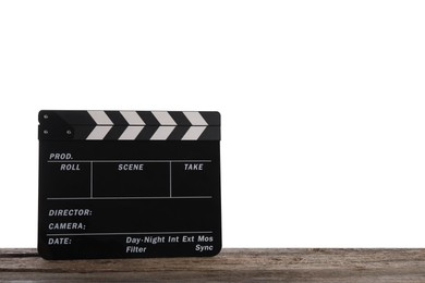 Movie clapper on wooden table against white background, space for text