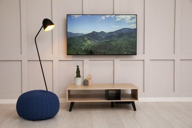 Photo of Modern TV on white wall in room