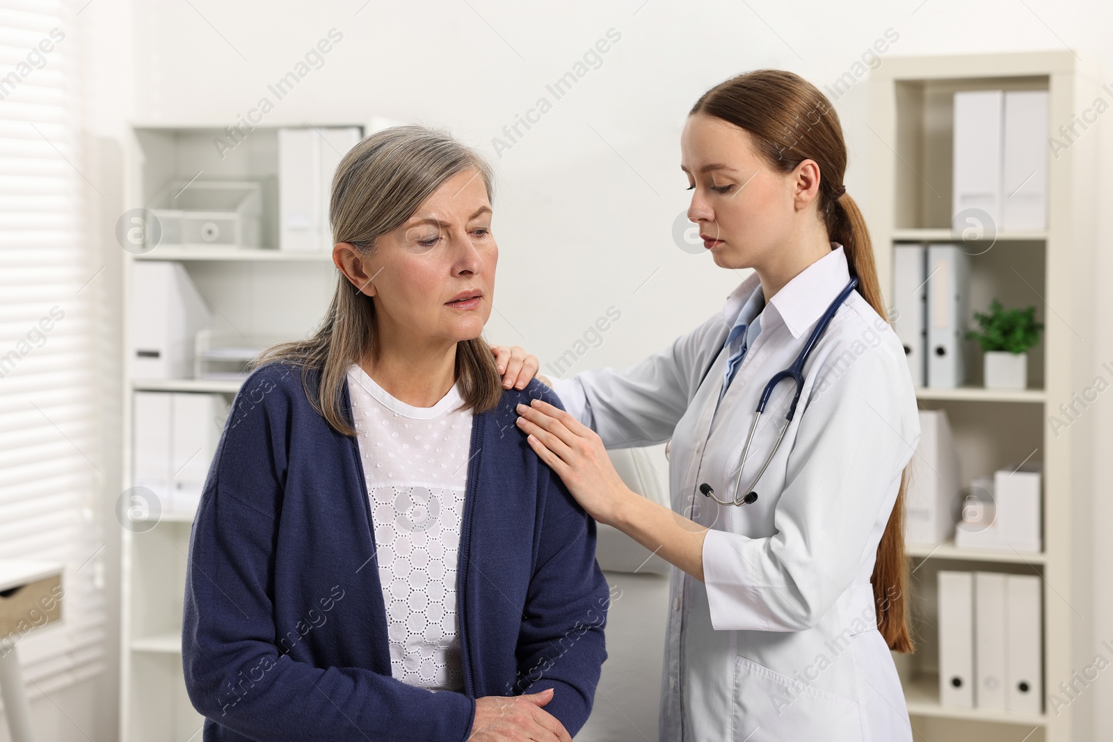 Photo of Arthritis symptoms. Doctor examining patient with shoulder pain in hospital