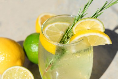 Photo of Summer refreshing lemonade and ingredients on light grey table, closeup