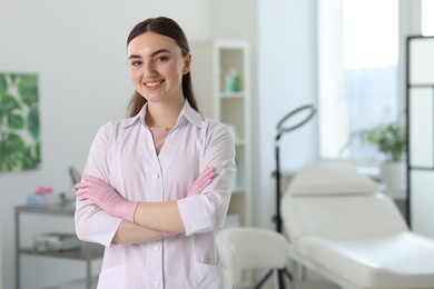 Photo of Cosmetologist in medical uniform in clinic, space for text