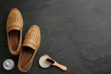 Photo of Flat lay composition with shoe care accessories and footwear on black background. Space for text