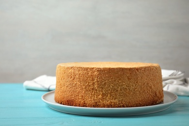 Photo of Delicious fresh homemade cake on light blue wooden table