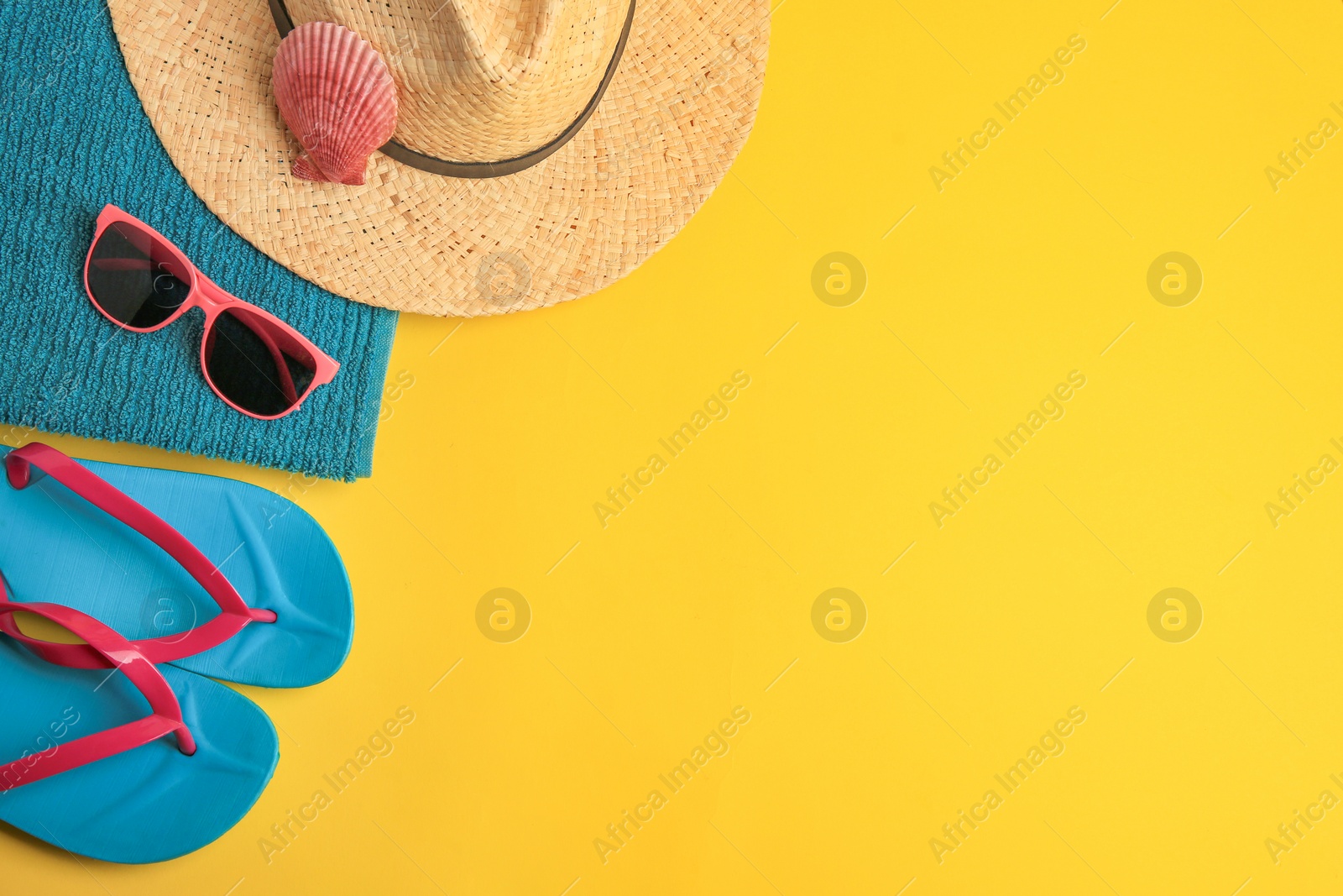 Photo of Flat lay composition with different beach accessories on yellow background. Space for text