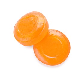Photo of Two orange cough drops on white background, top view