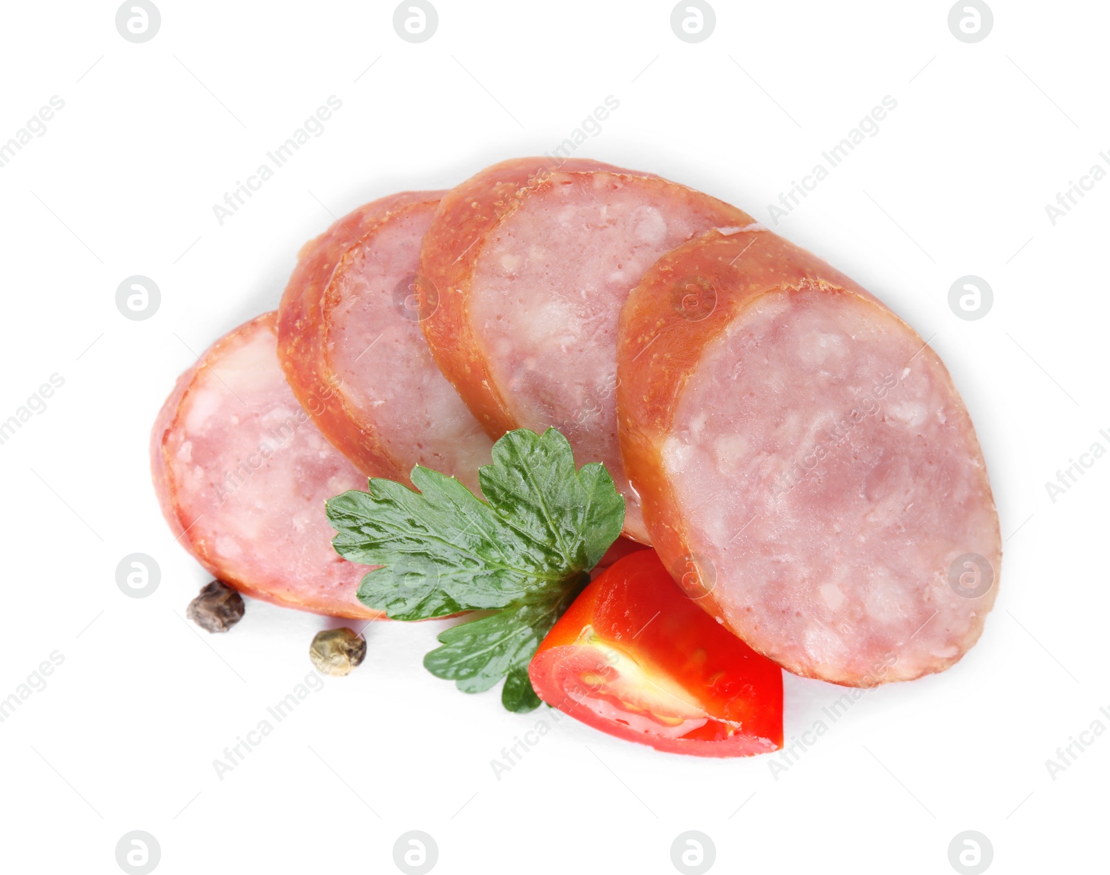 Photo of Slices of delicious smoked sausage with tomato and parsley isolated on white, top view