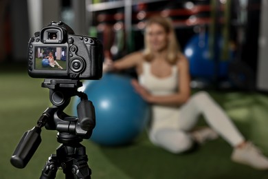 Fitness trainer recording online classes in gym