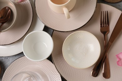 Stylish table setting with cutlery, cups and dishes, flat lay