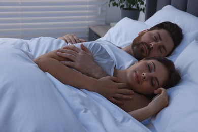 Photo of Lovely couple sleeping together in bed at night