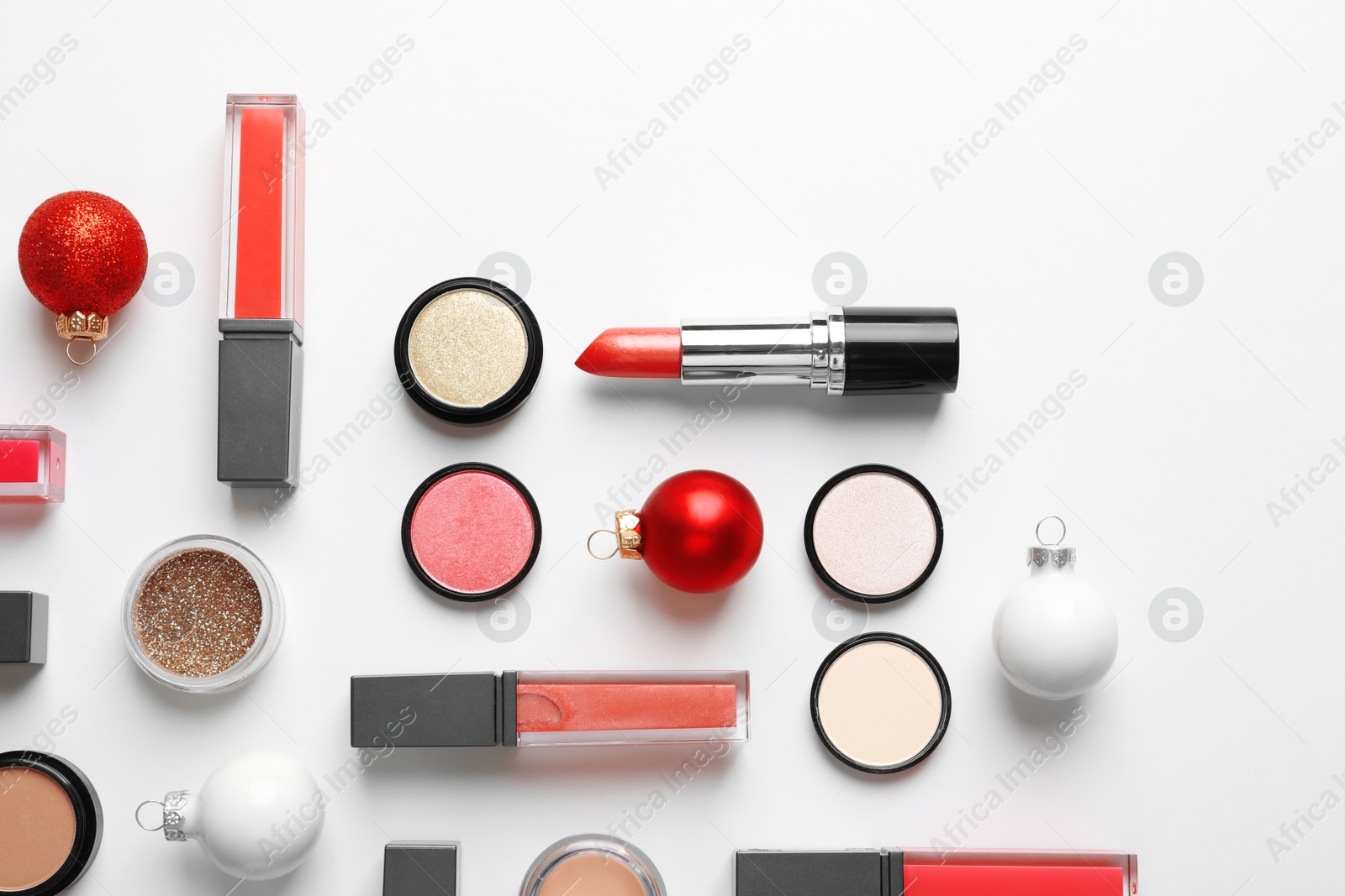 Photo of Flat lay composition with makeup products and Christmas decor on white background