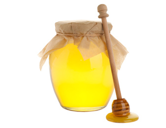 Photo of Glass jar of acacia honey and wooden dipper isolated on white