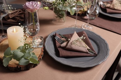Elegant table setting with beautiful floral decor and burning candles