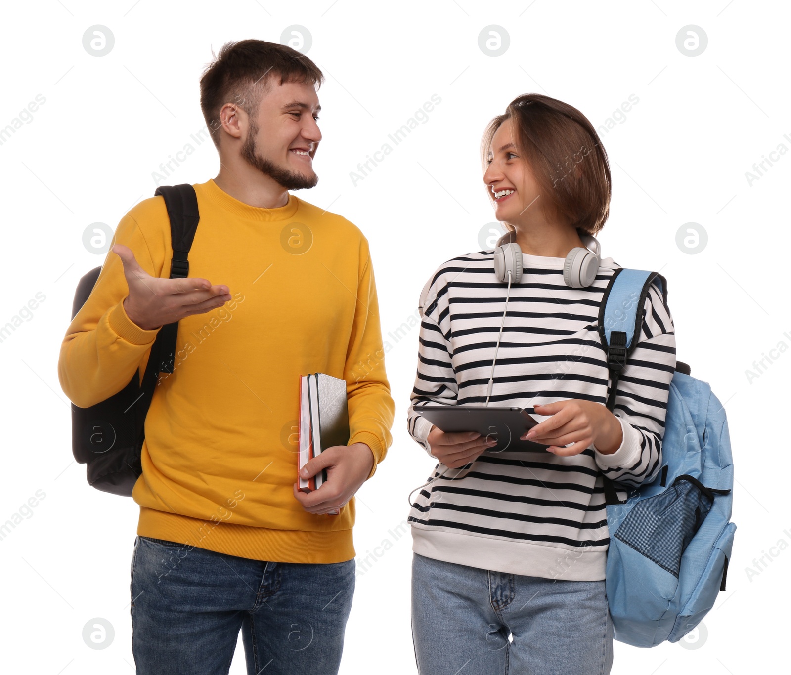 Photo of Young students with backpacks, books and tablet on white background