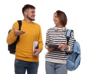 Photo of Young students with backpacks, books and tablet on white background