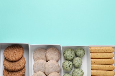 Photo of Many different raw vegan meat products on turquoise background, flat lay. Space for text
