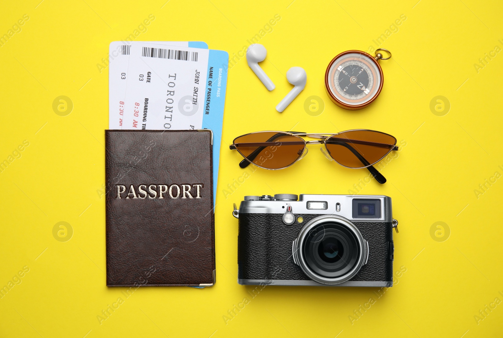 Photo of Flat lay composition with passport, tickets and travel items on yellow background