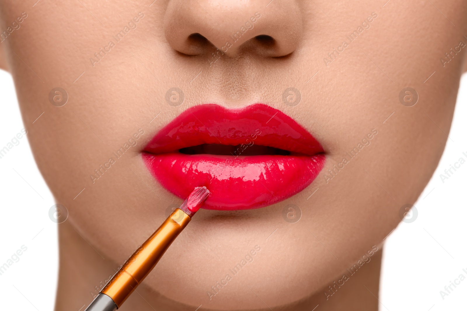 Photo of Woman applying lip gloss on white background, closeup