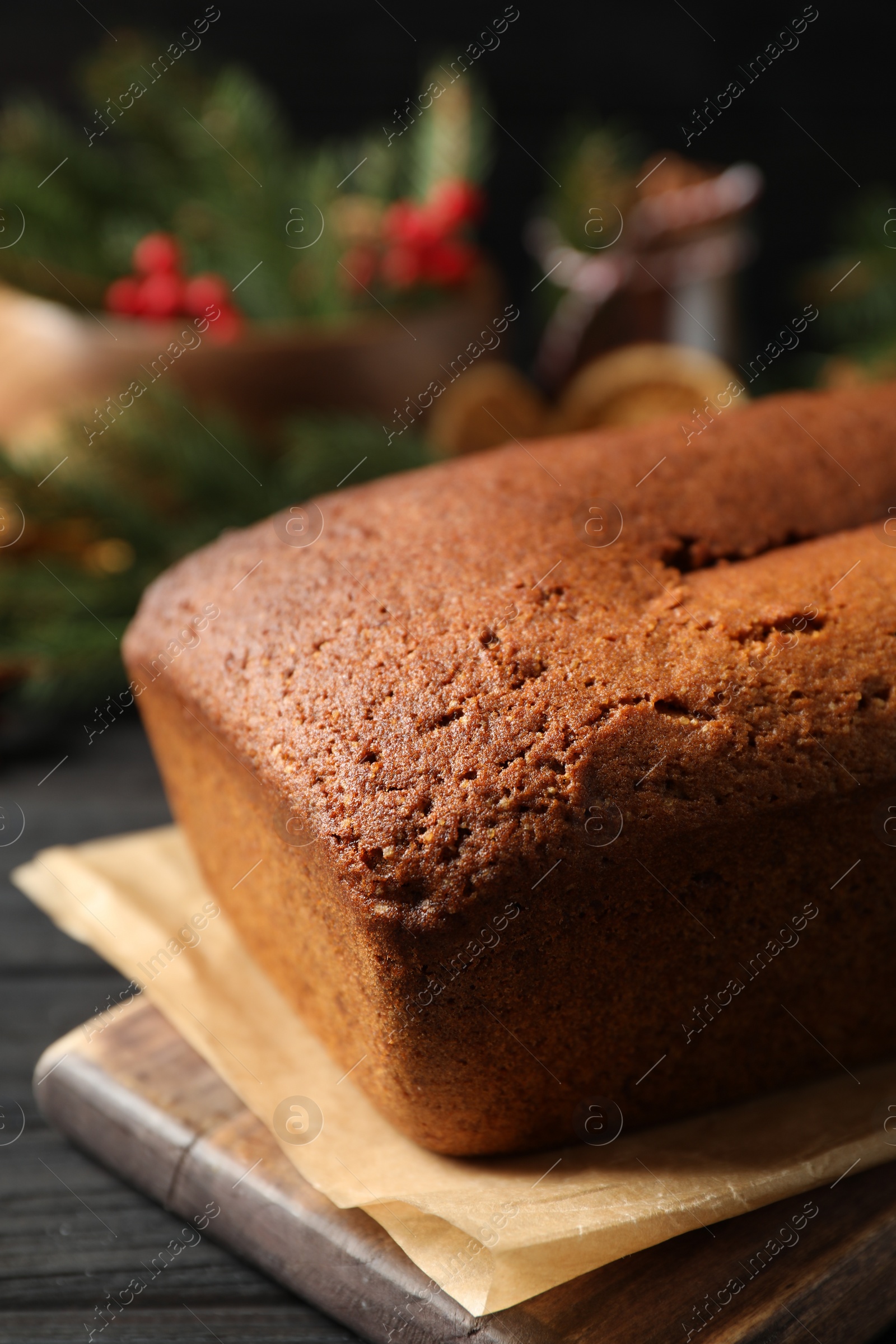 Photo of Delicious gingerbread cake on black wooden table, closeup