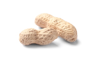 Photo of Raw peanuts in pods on white background