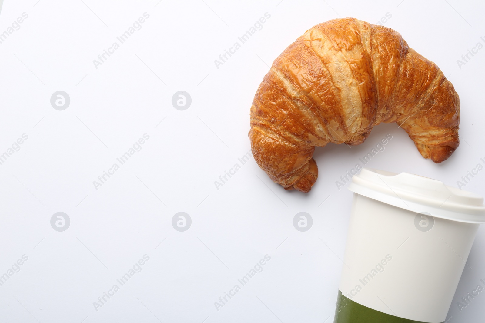 Photo of Delicious fresh croissant and paper cup with coffee on white background, flat lay. Space for text