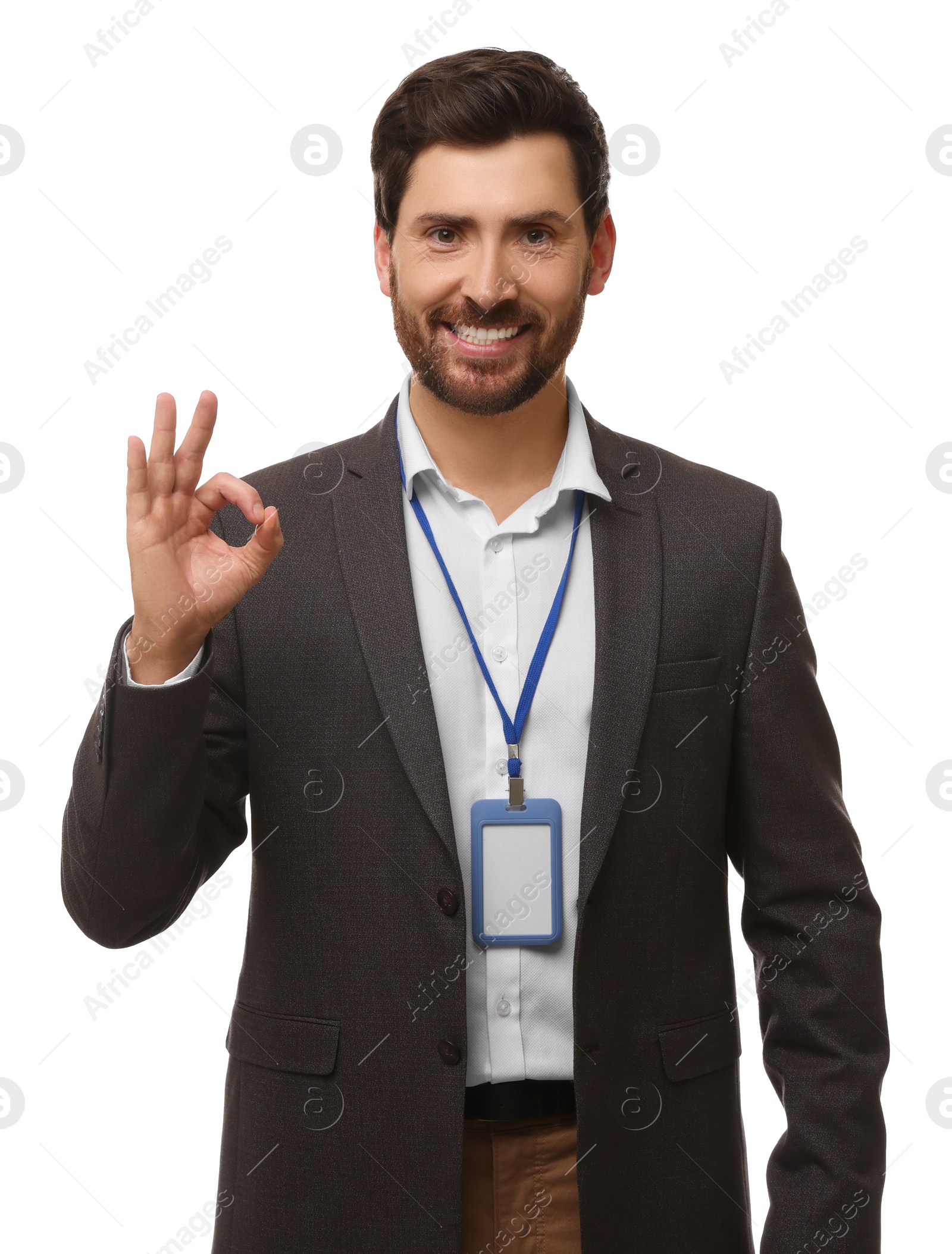 Photo of Smiling man with VIP pass badge showing OK gesture on white background