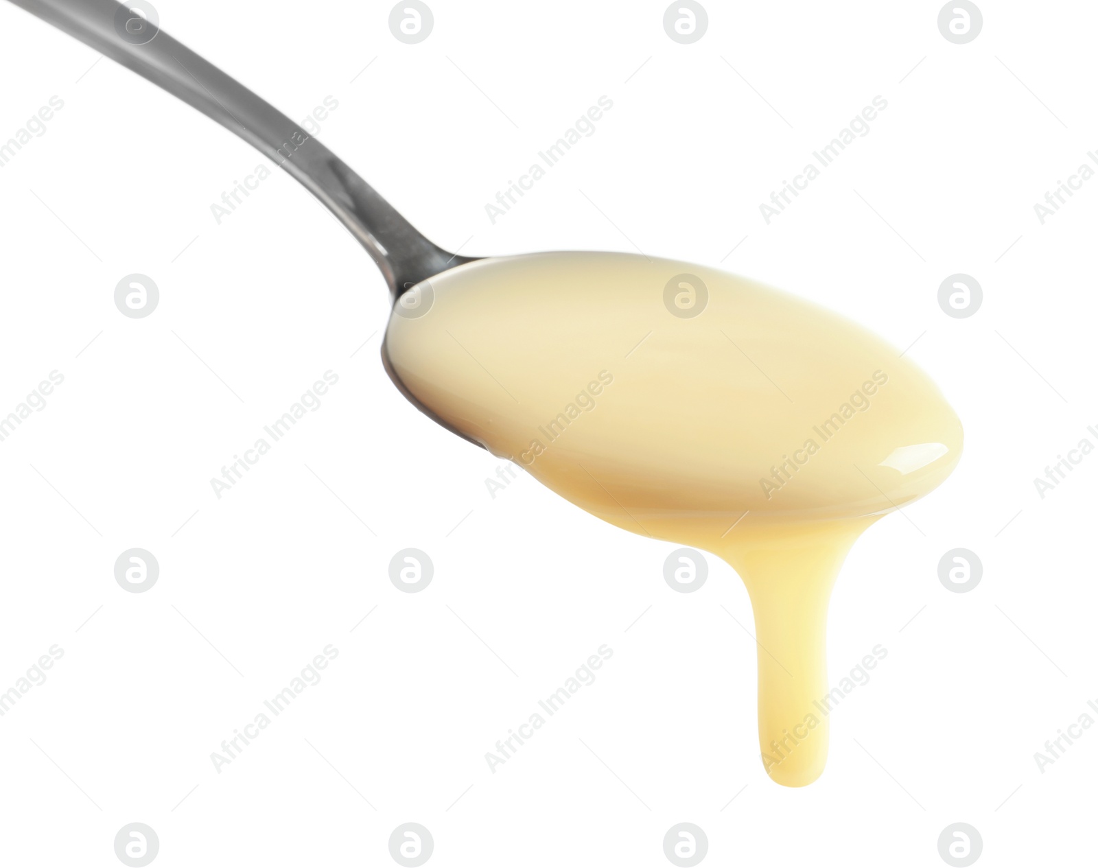 Photo of Spoon with condensed milk on white background, closeup. Dairy product