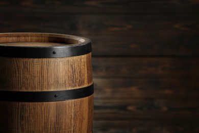 One wooden barrel near wall, closeup. Space for text