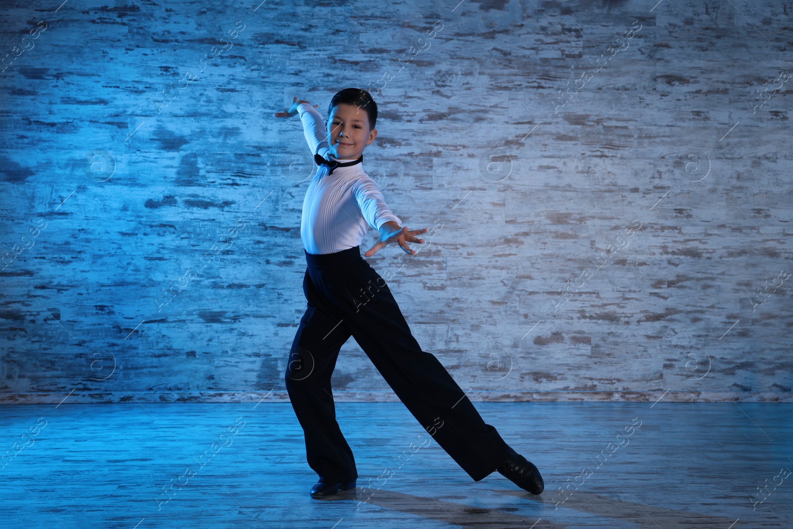 Photo of Beautifully dressed little boy dancing in studio