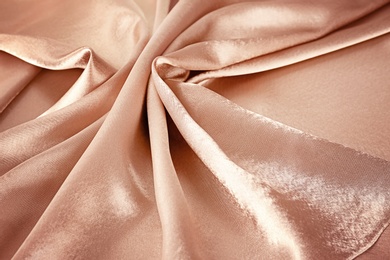 Texture of rose gold silk as background, closeup