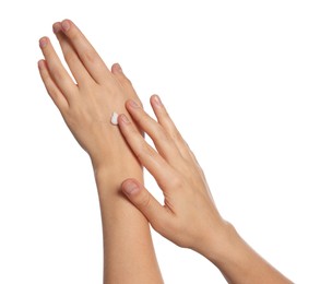 Woman applying cream on her hand against white background, closeup