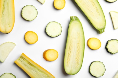 Photo of Fresh ripe cut zucchinis on white background, top view