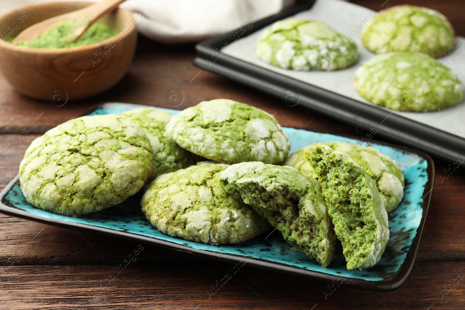 Photo of Tasty matcha cookies on wooden table, closeup