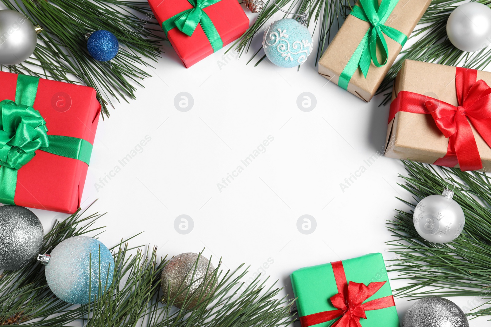 Photo of Frame made with Christmas gifts and festive decoration on white background, top view. Space for text