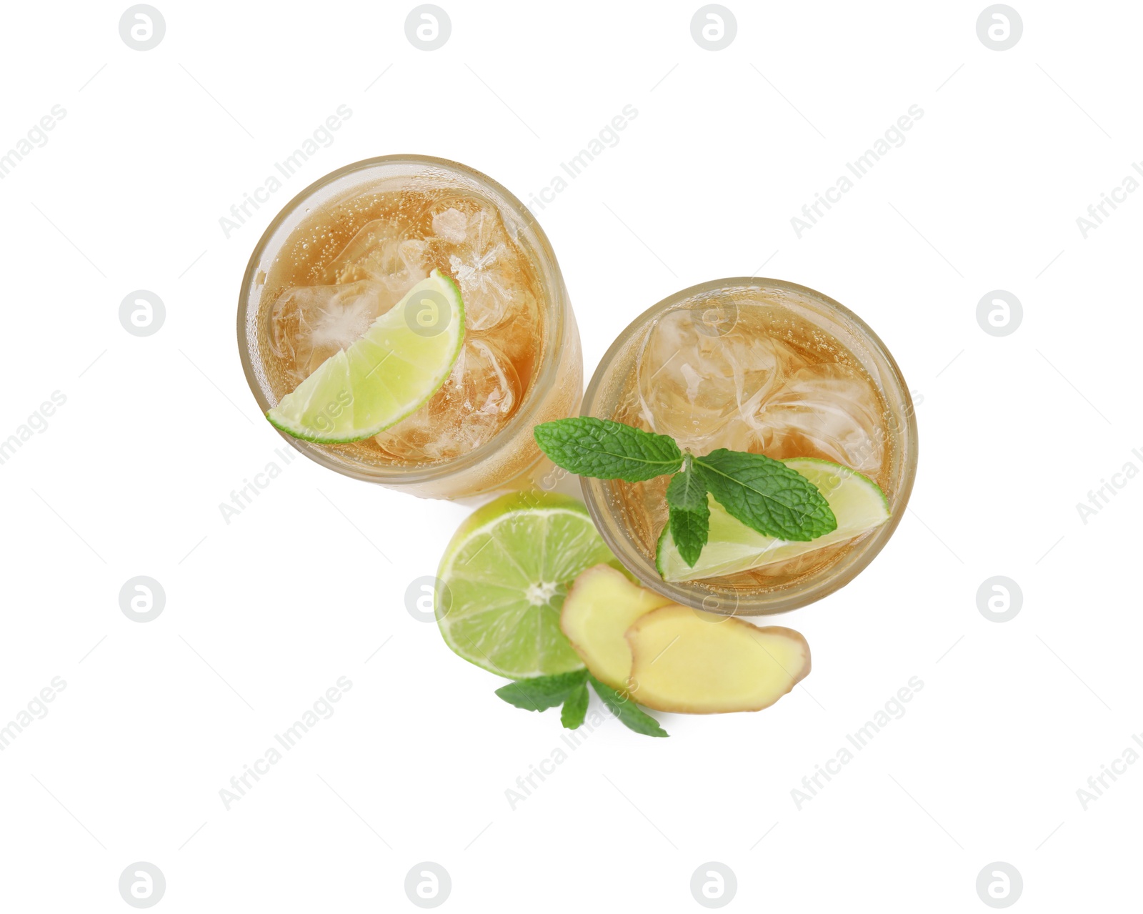 Photo of Glasses of tasty ginger ale with ice cubes and ingredients isolated on white, top view