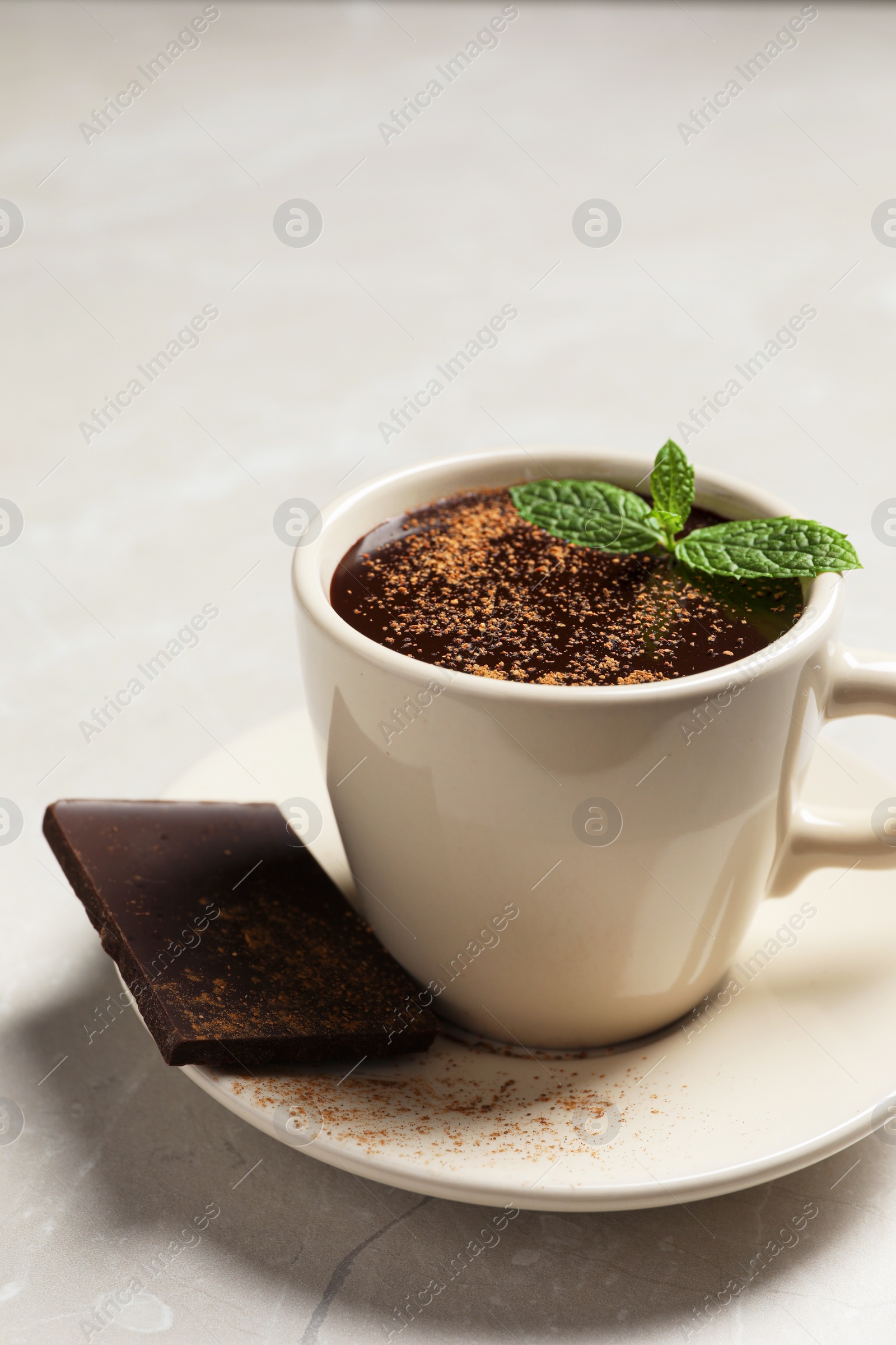 Photo of Cup of delicious hot chocolate with fresh mint on grey table, closeup