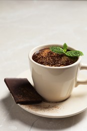 Photo of Cup of delicious hot chocolate with fresh mint on grey table, closeup